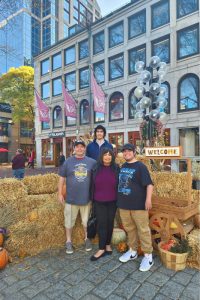 Four people standing in front of a hotel in Boston