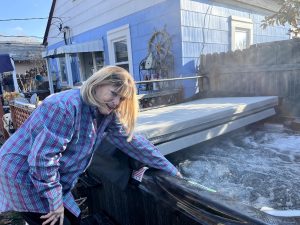 Woman standing by a hot tub